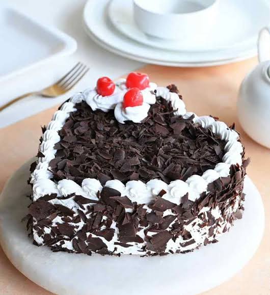 A black forest cake topped with cherries